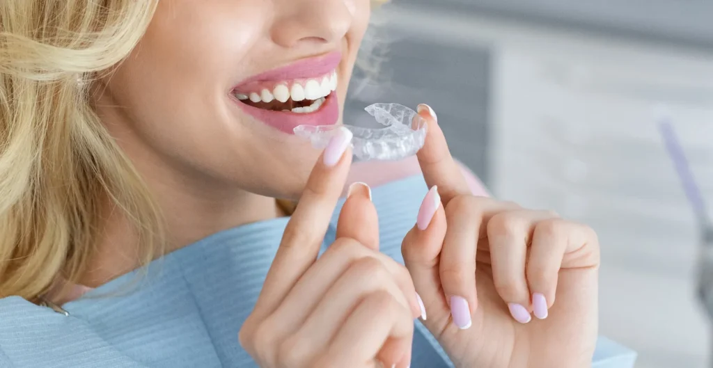 A woman placing a clear aligner
